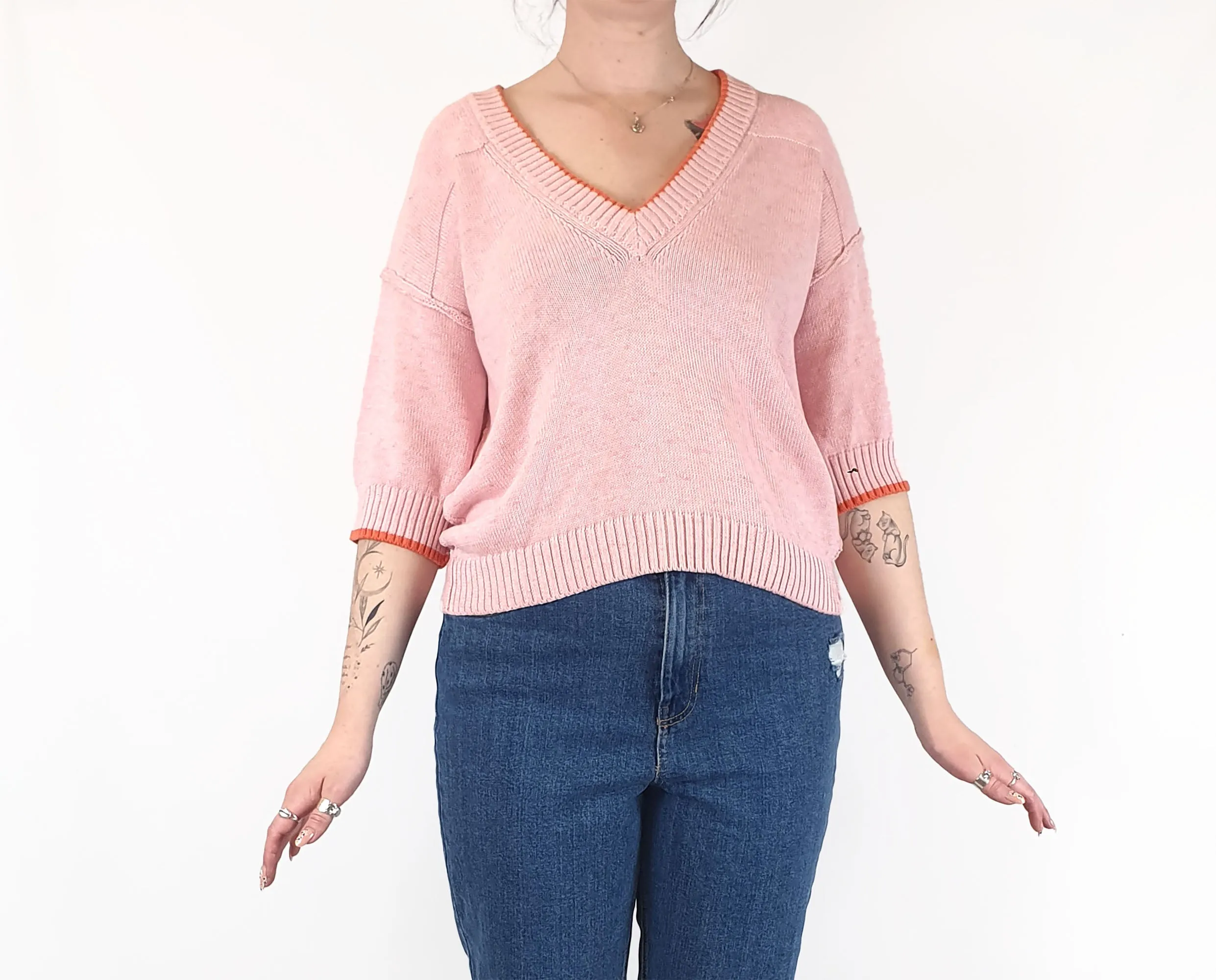 Pink half sleeve knit with orange trim fits size 12