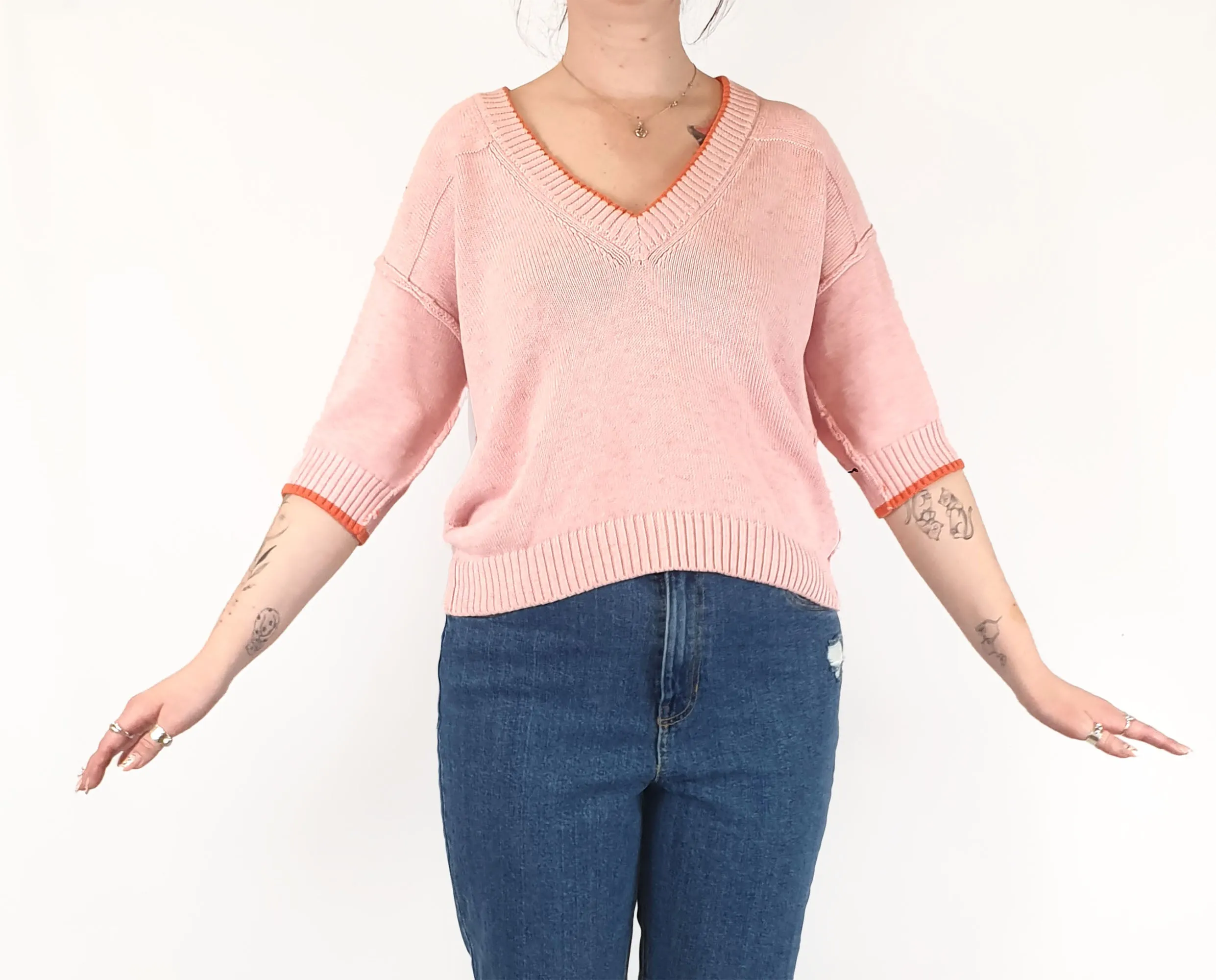 Pink half sleeve knit with orange trim fits size 12